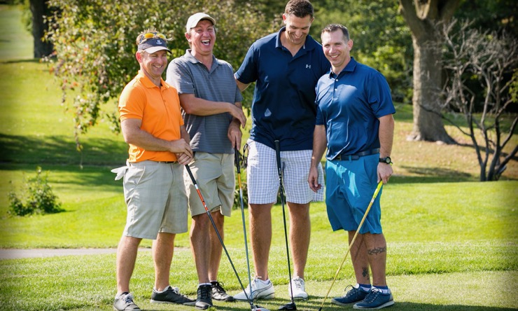 four people golfing