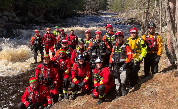 Shane with firefighters on river
